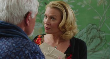 Movie still from “Dumb and Dumber To” (2014), directed by Peter Farrelly – A woman holding an envelope talking to a man in front of a wall; Close Up shot, Over the shoulder angle