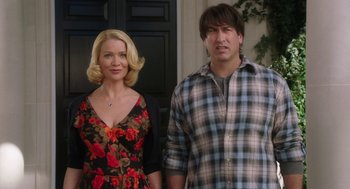 Movie still from “Dumb and Dumber To” (2014), directed by Peter Farrelly – A man and a woman standing next to each other in front of a door; Medium shot, Over the shoulder angle