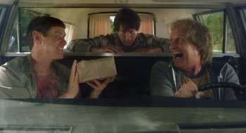 Movie still from “Dumb and Dumber To” (2014), directed by Peter Farrelly – Three men in the back of a car looking at a box; Medium shot, Low angle