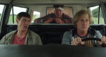 Movie still from “Dumb and Dumber To” (2014), directed by Peter Farrelly – Three people sitting in the back of a car; Medium shot, Over the shoulder angle
