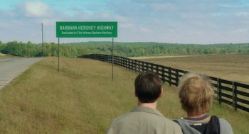 Movie still from “Dumb and Dumber To” (2014), directed by Peter Farrelly – Two people are looking at a road sign on the side of the road; Extreme Wide shot, High angle