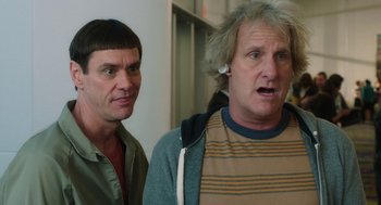 Movie still from “Dumb and Dumber To” (2014), directed by Peter Farrelly – Two men standing next to each other in front of a wall; Close Up shot, Over the shoulder angle