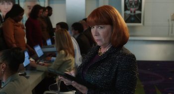 Movie still from “Dumb and Dumber To” (2014), directed by Peter Farrelly – A woman with red hair is holding a tablet; Close Up shot, Over the shoulder angle