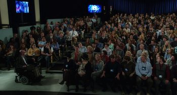 Movie still from “Dumb and Dumber To” (2014), directed by Peter Farrelly – A large group of people sitting in front of an audience; Wide shot, High angle