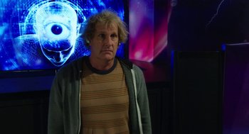 Movie still from “Dumb and Dumber To” (2014), directed by Peter Farrelly – An older man in front of an image of an eye; Close Up shot, Over the shoulder angle