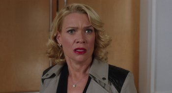 Movie still from “Dumb and Dumber To” (2014), directed by Peter Farrelly – A woman with blonde curly hair wearing a black and white jacket; Close Up shot, Over the shoulder angle