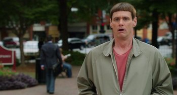 Movie still from “Dumb and Dumber To” (2014), directed by Peter Farrelly – A person wearing a jacket on a city street; Close Up shot, Over the shoulder angle