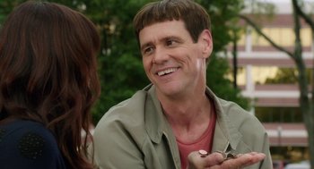 Movie still from “Dumb and Dumber To” (2014), directed by Peter Farrelly – A person smiling at a woman; Close Up shot, Over the shoulder angle