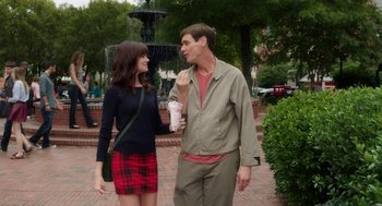 Movie still from “Dumb and Dumber To” (2014), directed by Peter Farrelly – A man and a woman standing next to each other on the sidewalk; Medium shot, Over the shoulder angle