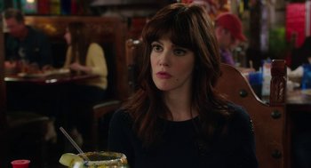 Movie still from “Dumb and Dumber To” (2014), directed by Peter Farrelly – A person sitting at a table with a bowl of food; Close Up shot, Over the shoulder angle