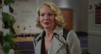 Movie still from “Dumb and Dumber To” (2014), directed by Peter Farrelly – A woman with blonde hair wearing a beige jacket; Close Up shot, Over the shoulder angle