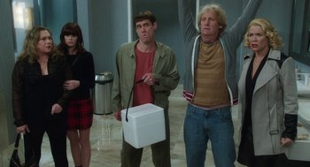 Movie still from “Dumb and Dumber To” (2014), directed by Peter Farrelly – A group of people standing next to each other in a room; Medium shot, Low angle