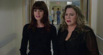 Movie still from “Dumb and Dumber To” (2014), directed by Peter Farrelly – Two women standing next to each other in a hallway; Close Up shot, Over the shoulder angle