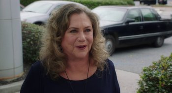 Movie still from “Dumb and Dumber To” (2014), directed by Peter Farrelly – A person with curly blonde hair; Close Up shot, Over the shoulder angle