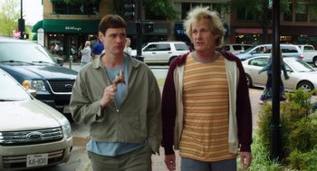 Movie still from “Dumb and Dumber To” (2014), directed by Peter Farrelly – Two men walking down the street holding hands; Medium shot, Low angle