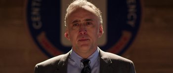 Movie still from “Dying of the Light” (2014), directed by Paul Schrader – A person wearing a suit and tie; Close Up shot, Low angle