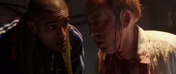 Movie still from “Dying of the Light” (2014), directed by Paul Schrader – A man with blood all over his face is looking at another man with blood all over his face; Close Up shot, Over the shoulder angle