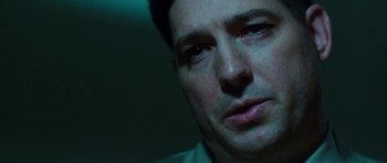 Movie still from “Dying of the Light” (2014), directed by Paul Schrader – A man's face in a dark room; Close Up shot, Over the shoulder angle