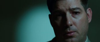 Movie still from “Dying of the Light” (2014), directed by Paul Schrader – A man's face in the dark; Close Up shot, Low angle
