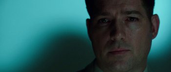 Movie still from “Dying of the Light” (2014), directed by Paul Schrader – A person's face in a dark room; Close Up shot, Low angle