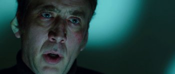 Movie still from “Dying of the Light” (2014), directed by Paul Schrader – A man's face in a dark room; Close Up shot, Low angle