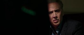 Movie still from “Dying of the Light” (2014), directed by Paul Schrader – Nicolas cage's face in the dark; Close Up shot, Over the shoulder angle