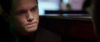 Movie still from “Dying of the Light” (2014), directed by Paul Schrader – A person wearing a suit; Close Up shot, Over the shoulder angle