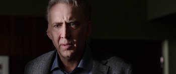 Movie still from “Dying of the Light” (2014), directed by Paul Schrader – A person wearing a suit and tie; Close Up shot, Over the shoulder angle