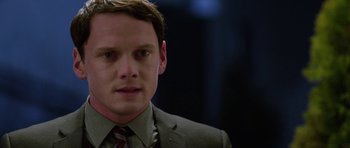 Movie still from “Dying of the Light” (2014), directed by Paul Schrader – A person wearing a suit and tie; Close Up shot, Over the shoulder angle