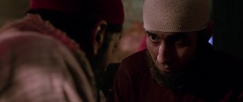 Movie still from “Dying of the Light” (2014), directed by Paul Schrader – A man with a bandage on his head is looking at another man; Close Up shot, Over the shoulder angle