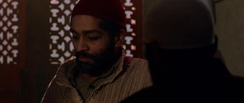 Movie still from “Dying of the Light” (2014), directed by Paul Schrader – A man with a beard and a red hat; Close Up shot, Over the shoulder angle