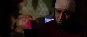 Movie still from “Dying of the Light” (2014), directed by Paul Schrader – A person with a bandage on his head; Close Up shot, Over the shoulder angle