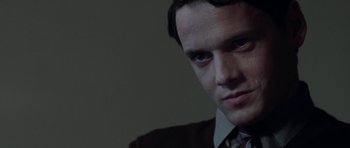 Movie still from “Dying of the Light” (2014), directed by Paul Schrader – A person wearing a suit and tie; Close Up shot, Low angle