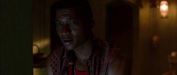 Movie still from “Dying of the Light” (2014), directed by Paul Schrader – A person with a necklace; Close Up shot, Over the shoulder angle