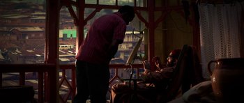 Movie still from “Dying of the Light” (2014), directed by Paul Schrader – A man standing in front of another man in front of a window; Wide shot, Over the shoulder angle