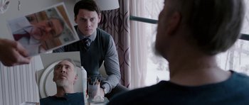 Movie still from “Dying of the Light” (2014), directed by Paul Schrader – A young man looking at himself in the mirror; Medium shot, Over the shoulder angle