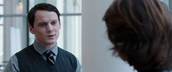 Movie still from “Dying of the Light” (2014), directed by Paul Schrader – A man in a vest and tie looking into a mirror; Close Up shot, Over the shoulder angle