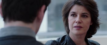 Movie still from “Dying of the Light” (2014), directed by Paul Schrader – A woman wearing a black leather jacket talking to a man; Close Up shot, Over the shoulder angle