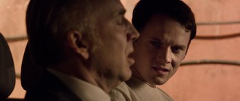Movie still from “Dying of the Light” (2014), directed by Paul Schrader – A man and another man are talking to each other; Close Up shot, Over the shoulder angle