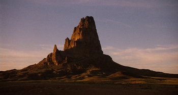 Movie still from “Easy Rider” (1969), directed by Dennis Hopper – A large rock formation in the middle of the desert; Extreme Wide shot, Low angle