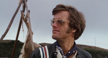 Movie still from “Easy Rider” (1969), directed by Dennis Hopper – A person wearing sunglasses and a leather jacket; Close Up shot, Low angle