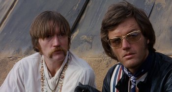 Movie still from “Easy Rider” (1969), directed by Dennis Hopper – A couple of men standing next to each other; Close Up shot, Low angle