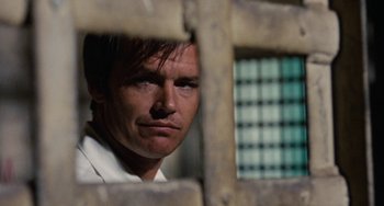 Movie still from “Easy Rider” (1969), directed by Dennis Hopper – A person behind a fence; Close Up shot, Low angle