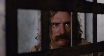Movie still from “Easy Rider” (1969), directed by Dennis Hopper – A person looking through a window; Close Up shot, Over the shoulder angle