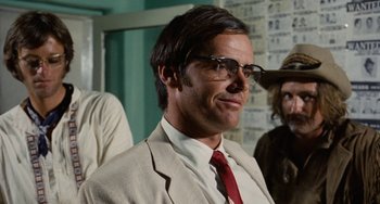 Movie still from “Easy Rider” (1969), directed by Dennis Hopper – A man in a tan suit and red neck tie; Close Up shot, Low angle