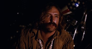 Movie still from “Easy Rider” (1969), directed by Dennis Hopper – A person with a beard and mustache; Close Up shot, Low angle