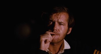 Movie still from “Easy Rider” (1969), directed by Dennis Hopper – A person holding his hand to his face; Close Up shot, Low angle