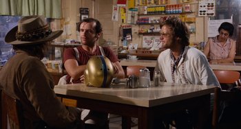 Movie still from “Easy Rider” (1969), directed by Dennis Hopper – Two men sitting at a table in a restaurant; Medium shot, Low angle