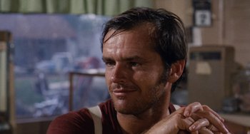 Movie still from “Easy Rider” (1969), directed by Dennis Hopper – A person wearing a red shirt; Close Up shot, Over the shoulder angle
