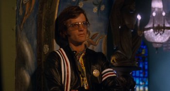 Movie still from “Easy Rider” (1969), directed by Dennis Hopper – A man in a leather jacket and glasses; Medium shot, Low angle